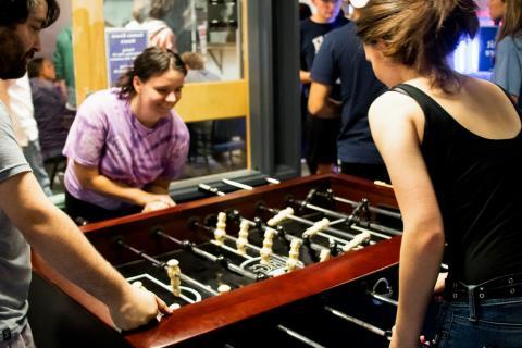 Students playing table football in Games Room